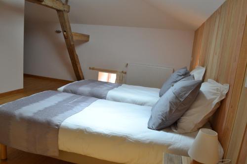 two beds in a small room with a lamp at LES GALAINES in Abzac