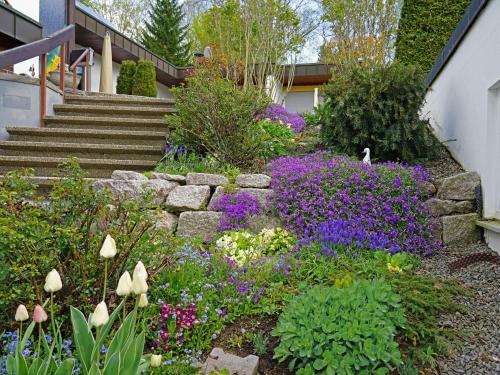 a garden with purple and purple flowers and stairs at Ferien-Oase Bad Dürrheim in Bad Dürrheim
