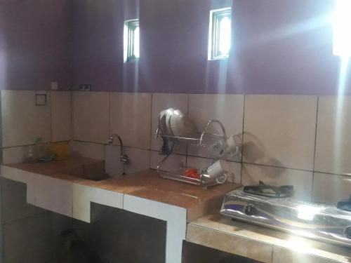 a kitchen with a sink and a counter top at Homestay Barokah in Magelang