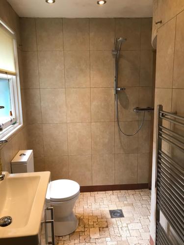 a bathroom with a toilet a sink and a shower at Ashtree House Hotel, Glasgow Airport & Paisley in Paisley