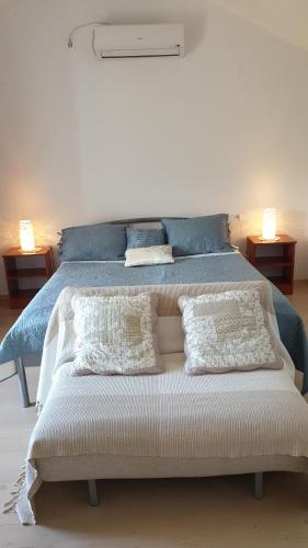 a bedroom with a bed with two pillows on it at Apartment Marina in Valun