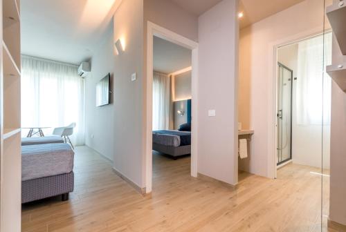 a living room with a bed and a couch at Hotel Relax Family & Spa in San Benedetto del Tronto