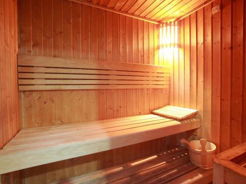 a wooden sauna with a wooden bench in it at Rose Garden Hotel Apartments - Al Barsha, Near Metro Station in Dubai