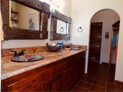 a bathroom counter with a sink and a mirror at Ocean Front Baja Vacation in Rosarito