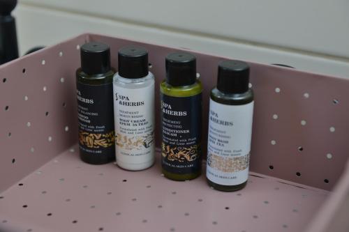 four bottles of spices sitting on a shelf at Apartman Filip in Novi Pazar