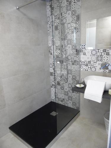 a bathroom with a shower and a sink at Chante Grelet in Châtel-Guyon