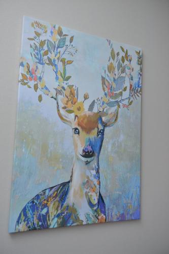 a painting of a deer with leaves on its horns at Apartman Filip in Novi Pazar