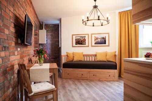 sypialnia z łóżkiem i ceglaną ścianą w obiekcie Apartamenty Pocztowa w Bydgoszczy