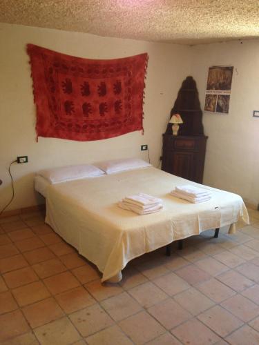 a bedroom with a bed with towels on it at Villa sul Mare Calalunga Calasetta Sant Antioco in Calasetta