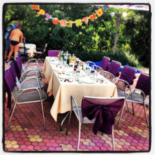 a group of tables and chairs with drinks on them at Park Hotel Green Europe in Haskovo