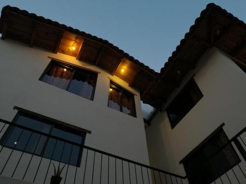 a house with lights in the windows at night at Ganesha Hotel in San Cristóbal de Las Casas