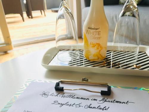 a bottle of wine sitting on top of a table at Berglust Und Seenliebe in Presseggersee