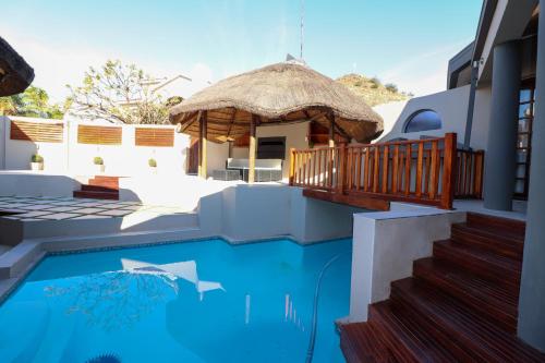 a house with a swimming pool and a gazebo at Stonehill Villa in Bloemfontein