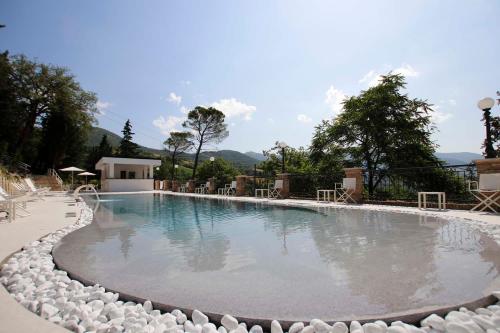 a large swimming pool with rocks around it at Marchese Del Grillo in Fabriano