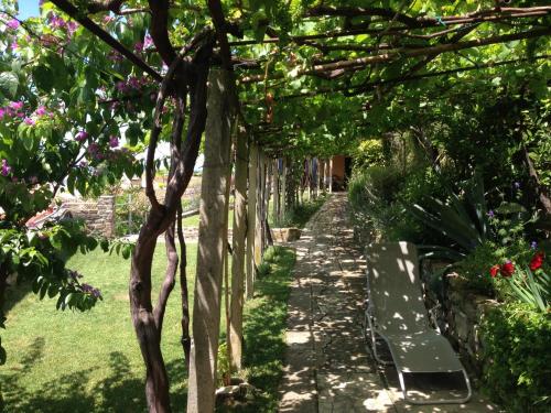 a path in a garden with a bench at Holiday Home Amazing View in Piran