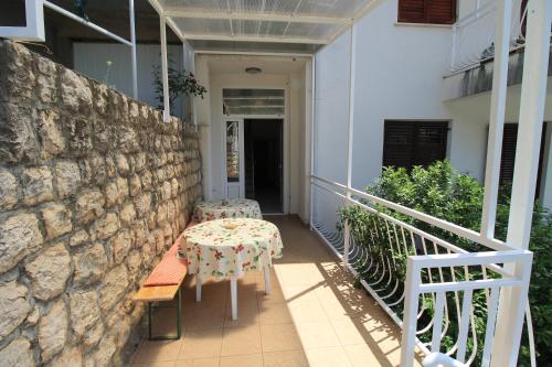a balcony with a table and chairs on a building at Villa Hortus in Neum