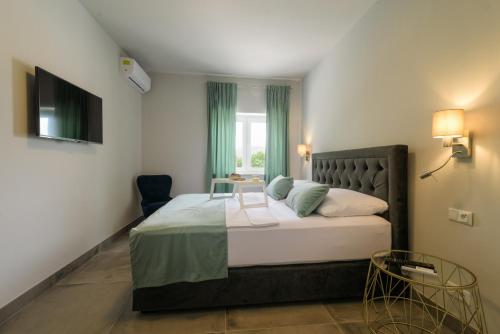 a bedroom with a bed with a table and a window at Villa Gala in Trogir