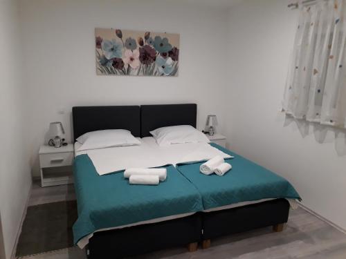 Postel nebo postele na pokoji v ubytování Apartments Roko