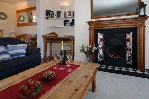 a living room with a coffee table and a fireplace at The Old Quayside House in Falmouth