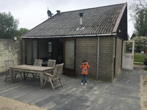 a little girl taking a picture of a house at Stellendam holiday house, near beaches in Stellendam