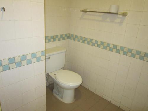 a bathroom with a white toilet in a room at Paradise Lagoon Apartment in Port Dickson