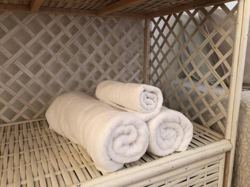 a bunch of towels sitting in a cage at Villa Domenico in Salvador