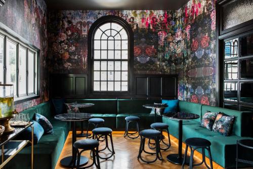 a restaurant with green booths and tables and a window at The Inchcolm in Brisbane