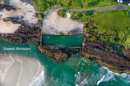 an overhead view of a beach and the ocean at Rockpool 2 Sawtell Beach - Just steps to Restaurants and 2 min Stroll to Beach! in Sawtell