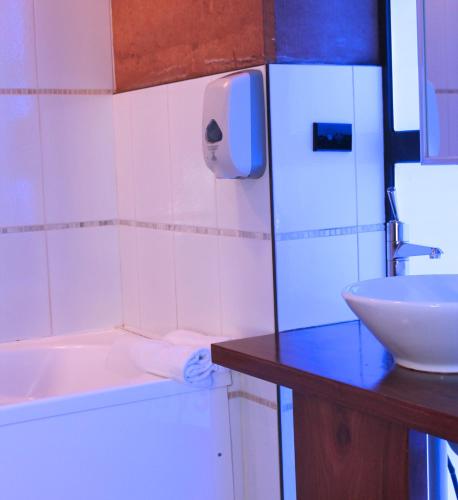 a bathroom with a sink and a tub and a toilet at The Pemberton Hotel in Pemberton