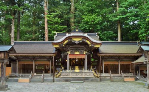 a temple in the middle of a forest at Kurumayama Kogen Guesthouse Urara in Chino