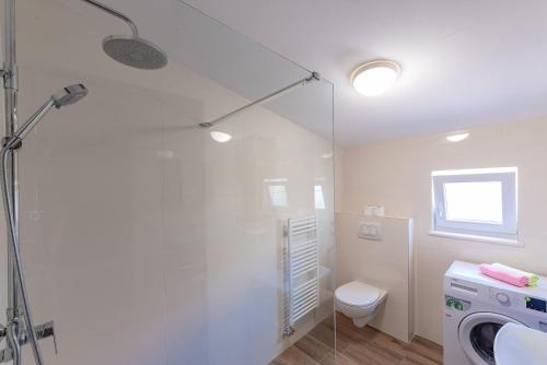 a bathroom with a shower and a washing machine at Apartments Dijana in Zadar