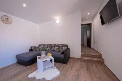 a living room with a couch and a table at Apartments Dijana in Zadar