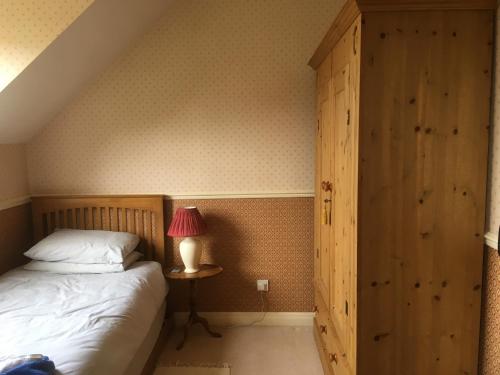 a bedroom with a bed and a table with a lamp at Southwold Bridlington in Bridlington