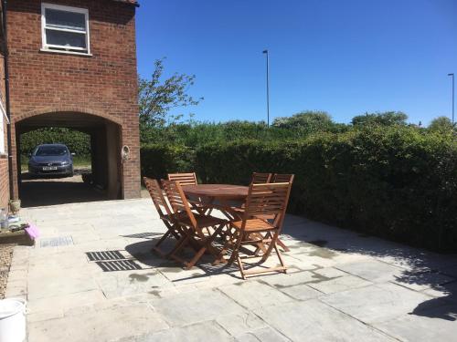 two chairs and a wooden table on a patio at Southwold Bridlington in Bridlington