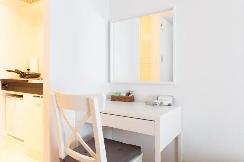 a white desk with a mirror and a chair at KIKU'S Room in Osaka