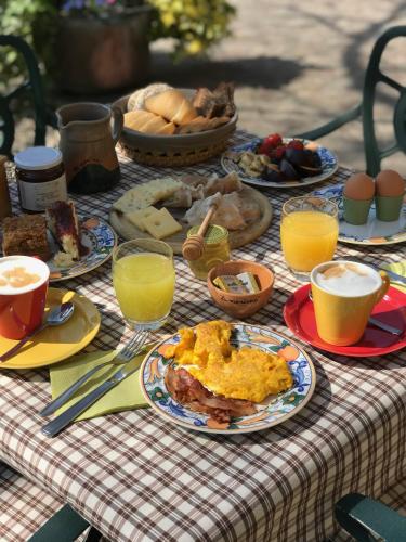 un tavolo con piatti di cibo e bicchieri di succo d'arancia di Agriturismo La Montina a Ponti Sul Mincio