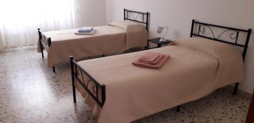 a room with three beds with towels on them at Civico 27 - In Terrazza in Casalbordino