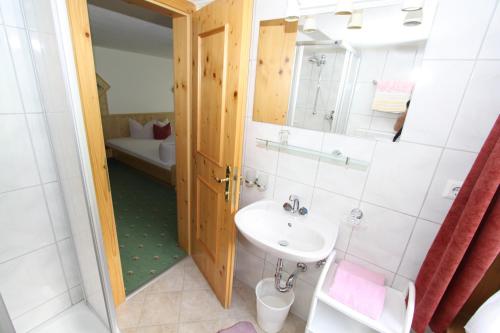 een badkamer met een wastafel en een spiegel bij Haus Bödele in Sankt Leonhard im Pitztal