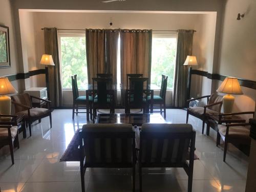a dining room with a table and chairs at Jasmine Inn in Islamabad