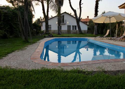 a swimming pool in the yard of a house at Katana suites beach in Agnone Bagni