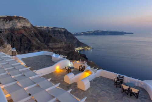 a view of the ocean from the top of a cliff at Caldera Butterfly Villas in Fira