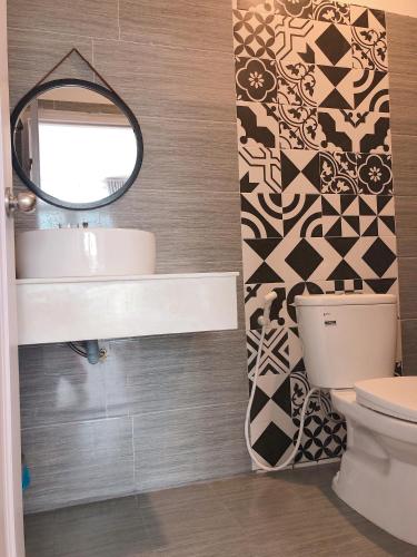 a bathroom with a sink and a mirror at Sele House in Ha Tien