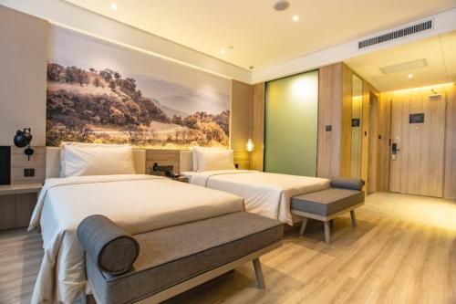 A bed or beds in a room at Atour Hotel Xi'an Gaoxin Jinye Road Branch