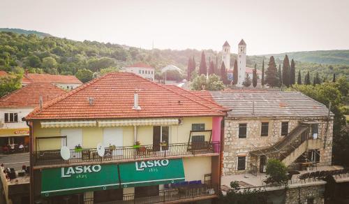 a group of people sitting on a balcony of a building at Apartman Vendi in Zagvozd