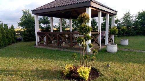 a gazebo in the middle of a field at Gospodarstwo Rospuda in Bakałarzewo