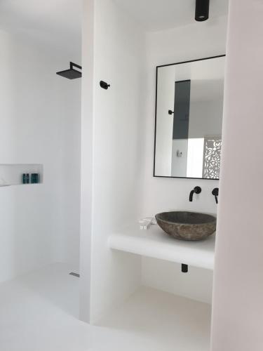 a bathroom with a sink and a mirror at Bellou Suites in Mýkonos City