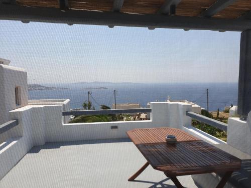 a balcony with a table and a view of the ocean at Bellou Suites in Mýkonos City