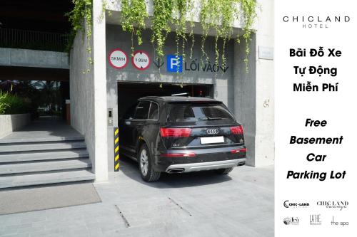 a black suv parked in a parking lot at Chicland Boutique Danang Beach Hotel in Da Nang