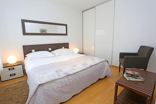 a bedroom with a bed and a chair and a table at Luxury Apts Leone Split Centre in Split