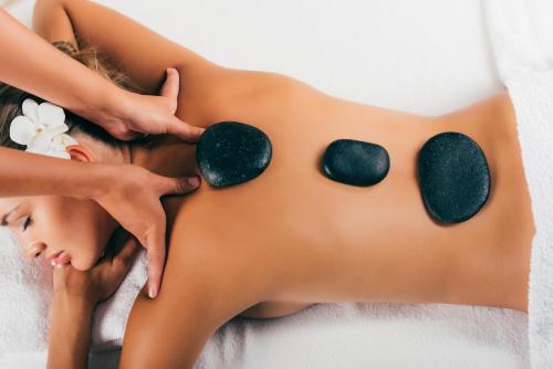 a woman lying on a towel in a spa with spaaceuticalaceuticalaceuticalaceuticalaceutical at Kia Orana Villas and Spa in Rarotonga